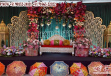 Royal Moroccan Style Mehndi Stage Decor Luxury Moroccan Mehndi stage decor featuring intricate laser cut backdrop panels, colorful floral arrangements, traditional lanterns, and royal wedding sofa