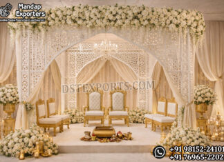 Luxury White Laser Cut Wedding Mandap For Australia Luxury White Laser Cut Wedding Mandap For Australia featuring intricate laser cut backdrop panels, colorful floral arrangements, traditional lanterns, and royal wedding sofa