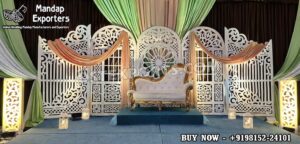 Luxury Moroccan Mehndi stage decor featuring intricate laser cut backdrop panels, colorful floral arrangements, traditional lanterns, and royal wedding sofa