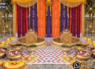 South Asian Haldi Function Stage with Traditional Decor Props Haldi ceremony stage with marigold decorations, colorful drapes, brass urlis, floral rangoli, and traditional Indian wedding decor setup
