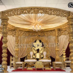 South Indian wedding mandap, manavarai mandap design, temple style wedding mandap, gold wedding mandap for sale, carved wooden mandap India, luxury wedding mandap setup, traditional Hindu wedding mandap, royal wedding stage mandap, antique gold mandap design, premium mandap for wedding, Indian wedding mandap manufacturers, wedding mandap exporters India, decorative mandap pillars carved, mandap with dome canopy, classic temple mandap design, wedding stage furniture supplier, grand wedding mandap setup, banquet hall mandap decoration, designer mandap for marriage