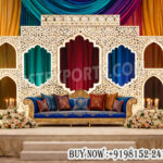Arabian night wedding backdrop, Moroccan wedding stage decor, laser cut wedding panels backdrop, royal wedding stage setup, colorful drape wedding backdrop, Mughal style wedding backdrop panels, luxury wedding stage decoration, designer wedding backdrop India, sangeet stage backdrop ideas, themed wedding stage décor, illuminated laser cut panels, wedding stage with lantern décor, Arabic style wedding stage setup, vibrant wedding backdrop design, premium event backdrop panels, wedding furniture exporters India, decorative wedding stage panels, banquet hall wedding backdrop setup