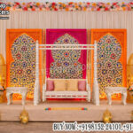 mehndi stage decoration, Arabian theme wedding stage, colorful mehndi backdrop, laser cut panels mehndi stage, Moroccan wedding decor setup, jhula mehndi stage setup, haldi ceremony stage decoration, sangeet stage backdrop design, vibrant wedding stage decor, designer mehndi backdrop panels, wedding stage with lanterns, luxury mehndi setup India, event decor exporters India, decorative wedding panels supplier, engagement stage colorful backdrop, wedding swing stage setup, festive wedding decor ideas, banquet hall mehndi stage setup