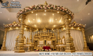 South Indian wedding mandap, manavarai mandap design, temple style wedding mandap, gold wedding mandap for sale, carved wooden mandap India, luxury wedding mandap setup, traditional Hindu wedding mandap, royal wedding stage mandap, antique gold mandap design, premium mandap for wedding, Indian wedding mandap manufacturers, wedding mandap exporters India, decorative mandap pillars carved, mandap with dome canopy, classic temple mandap design, wedding stage furniture supplier, grand wedding mandap setup, banquet hall mandap decoration, designer mandap for marriage