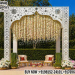 outdoor wedding mandap, mirror mandap outdoor setup, garden wedding mandap design, white wedding mandap India, floral hanging mandap decor, destination wedding mandap setup, elegant wedding mandap backdrop, modern outdoor mandap design, wedding mandap with floral strings, luxury wedding mandap for sale, Indian wedding mandap manufacturers, mandap exporters India, engagement mandap outdoor, decorative mandap panels carved, premium wedding mandap setup, wedding stage mandap outdoor design, minimalist wedding mandap backdrop