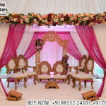 wedding mandap chair set, draped wedding mandap setup, Buddhist wedding mandap decor, traditional wedding mandap chairs, carved wooden wedding chairs, wedding stage mandap setup, fabric draped mandap design, floral mandap canopy decoration, engagement mandap setup, cultural wedding stage decor, indoor wedding mandap design, wedding decor exporters India, mandap furniture supplier, ceremonial wedding seating set, designer wedding mandap setup, banquet hall mandap decor, premium wedding stage furniture