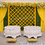 haldi stage decoration, marigold haldi backdrop, haldi ceremony setup India, green wall haldi decor, haldi stage with flowers, lotus seating haldi setup, traditional haldi backdrop design, floral haldi stage decor, mehndi haldi stage setup, yellow theme haldi decoration, marigold lattice backdrop, haldi event decor supplier, wedding haldi decor India, festive haldi stage design, indoor haldi setup ideas, event decor exporters India, haldi backdrop panels supplier