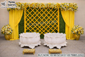 haldi stage decoration, marigold haldi backdrop, haldi ceremony setup India, green wall haldi decor, haldi stage with flowers, lotus seating haldi setup, traditional haldi backdrop design, floral haldi stage decor, mehndi haldi stage setup, yellow theme haldi decoration, marigold lattice backdrop, haldi event decor supplier, wedding haldi decor India, festive haldi stage design, indoor haldi setup ideas, event decor exporters India, haldi backdrop panels supplier