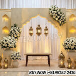 arabian night wedding stage, candle wall wedding backdrop, nikkah stage decoration, arabic wedding backdrop panels, wedding stage with lanterns, candle lit wedding stage decor, luxury wedding backdrop design, modern wedding stage panels, engagement stage backdrop design, wedding decor exporters India, event decor supplier India, floral wedding stage backdrop, premium wedding stage setup, banquet hall wedding stage decor, elegant wedding backdrop panels