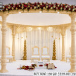 circular wedding mandap, wooden wedding mandap, carved mandap design, round mandap for wedding, luxury wedding mandap, traditional mandap setup, Indian wedding mandap, floral mandap decoration, premium mandap design, wedding stage mandap, carved pillar mandap, elegant wedding mandap, Hindu wedding mandap, mandap exporters, designer wedding mandap