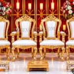 Golden vedi chair set, Hindu wedding chair setup, wedding vedi décor, floral wedding backdrop, traditional wedding seating, Sankheda wedding furniture, luxury wedding vedi, Indian wedding mandap chairs, ceremonial wedding chair set, wedding stage seating, floral arch wedding décor, peacock wedding backdrop, premium wedding furniture, royal wedding setup, Hindu marriage décor, wedding ritual seating, decorative vedi chairs, luxury mandap seating, engagement stage décor, banquet wedding setup Luxury Maharaja & Maharani Mandap Chair Collection Traditional Bollywood Style Golden Mandap Chair Set