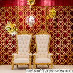 gold laser cut backdrop, wedding stage decor, laser cut wedding panels, luxury wedding backdrop, royal wedding stage, geometric backdrop panels, reception stage setup, wedding throne chairs, elegant stage decoration, gold backdrop design, wedding event decor, premium wedding stage, decorative laser cut panels, wedding backdrop panels, mandap exporters decor