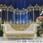 wedding arch backdrop, luxury wedding stage décor, golden arch stand backdrop, floral wedding stage, royal wedding loveseat, reception stage decoration, engagement stage décor, wedding backdrop panels, elegant wedding setup, floral event backdrop, luxury stage furniture, wedding stage manufacturers, decorative wedding arches, designer wedding stage, wedding floral décor, wedding sofa set, banquet stage decoration, royal event décor, luxury reception setup, premium wedding backdrop