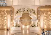 Luxury Arangetram Stage Decoration With Big Elephants Luxury Arangetram stage decoration with golden carved backdrop panels, large white elephant statues, floral arch décor, and elegant warm lighting for a traditional South Indian cultural event.