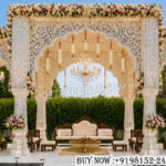 Outdoor wedding mandap, Mehrab style mandap, mirror wedding mandap, luxury wedding mandap, carved wedding mandap, floral wedding stage, Indian wedding mandap, royal wedding mandap, outdoor ceremony mandap, decorative mandap setup, palace style mandap, wedding stage décor, elegant wedding canopy, mandap manufacturers, wedding mandap exporters