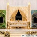 Mehrab stage backdrop, mosque theme wedding decor, laser cut wedding panels, Islamic wedding stage, colorful wedding backdrop, Mughal style stage decor, wedding laser cut panels, royal wedding stage setup, Muslim wedding decor, decorative mehrab backdrop, luxury stage backdrop, wedding sofa stage decor, event stage panels, illuminated wedding backdrop, mandap exporters decor