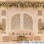 Mughal wedding backdrop, white wooden wedding stage, jali wedding backdrop, luxury wedding stage decor, carved wooden backdrop, laser cut wedding panels, Mughal style stage decor, royal wedding backdrop, floral wedding stage, wooden wall backdrop, designer wedding stage, white stage decor, wedding reception backdrop, luxury event backdrop, mandap exporters decor