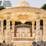 south indian wedding mandap, temple style wedding mandap, manavarai mandap design, hindu wedding mandap decoration, white gold wedding mandap, traditional wedding mandap India, luxury wedding mandap setup, carved mandap pillars, muhurtham stage decoration, wedding mandap exporters India, premium mandap design, temple theme wedding decor, indian wedding stage mandap, decorative mandap supplier