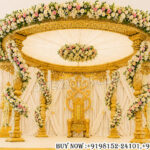 Golden wedding mandap, Tamil wedding mandap, South Indian wedding stage decor, round mandap design, luxury wedding mandap, floral wedding mandap, carved mandap for weddings, traditional Indian wedding mandap, royal wedding stage setup, premium mandap decoration, wedding canopy decor, Hindu wedding mandap, grand mandap setup, elegant mandap design, wedding stage backdrop, decorative mandap for reception, luxury wedding decor India, floral mandap decoration, South Indian mandap manufacturers, wedding mandap exporters