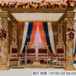 Tamil wedding mandap, golden FRP mandap, crystal wedding mandap, traditional Hindu mandap, South Indian wedding décor, luxury wedding mandap, carved FRP pillars, Tamil marriage mandap, Sankheda wedding seating, wedding ceremony mandap, floral mandap decoration, premium wedding stage, decorative mandap pillars, Indian wedding canopy, royal wedding mandap setup, banquet hall mandap décor, engagement ceremony mandap, handcrafted wedding mandap, cultural wedding stage, designer wedding mandap, luxury Hindu wedding setup, FRP wedding décor, traditional marriage stage, elegant mandap decoration, destination wedding mandap