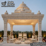 south indian wedding mandap, temple style wedding mandap, manavarai mandap design, hindu wedding mandap decoration, white gold wedding mandap, traditional wedding mandap India, luxury wedding mandap setup, carved mandap pillars, muhurtham stage decoration, wedding mandap exporters India, premium mandap design, temple theme wedding decor, indian wedding stage mandap, decorative mandap supplier