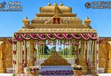 Traditional Wedding Gajalakshmi Design Manavarai Mandap Grand golden South Indian wedding mandap featuring intricate temple-style carvings, Gajalakshmi elephant motifs, decorative pillars, floral garlands, and an ornate bridal seating setup.