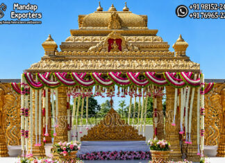 Traditional Wedding Gajalakshmi Design Manavarai Mandap Grand golden South Indian wedding mandap featuring intricate temple-style carvings, Gajalakshmi elephant motifs, decorative pillars, floral garlands, and an ornate bridal seating setup.