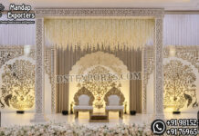 Contemporary Indian Wedding Mirror Theme Stage For Reception destination wedding mandap, fusion wedding pavilion mandap, luxury wedding canopy, outdoor wedding mandap, white and gold wedding mandap, laser cut wedding mandap, Islamic style wedding mandap, Mughal inspired mandap, royal wedding pavilion, designer wedding mandap setup, premium wedding mandap décor, floral wedding mandap, crystal hanging mandap, luxury phera mandap, wedding stage decoration, modern wedding mandap design, elegant wedding canopy setup, destination wedding decor Royal Mughal Wedding Stage Backdrop, Mughal Arch Wedding Backdrop, Fiber Wedding Stage Panels, Luxury Wedding Stage Decor, Arabic Wedding Backdrop, Muslim Wedding Stage Setup, Nikkah Stage Decoration, Walima Stage Backdrop, Reception Stage Design, Wedding Backdrop Manufacturer, FRP Wedding Panels, Carved Wedding Backdrop, Indian Wedding Stage Decor, Heritage Wedding Backdrop, Dome Arch Backdrop Panels, Event Stage Decoration, Wedding Furniture Set, Royal Wedding Sofa Set, Bride Groom Stage Setup
