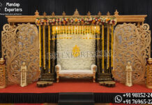 Dravidian Carved Pillars With Panels for Ritu Kala Samskaram Luxurious traditional Ritu Kala Samskaram stage featuring intricately carved Dravidian wooden pillars, decorative floral panels, hanging garlands, temple-style backdrop, and elegant ceremonial seating.