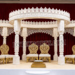 destination wedding mandap, fusion wedding pavilion mandap, luxury wedding canopy, outdoor wedding mandap, white and gold wedding mandap, laser cut wedding mandap, Islamic style wedding mandap, Mughal inspired mandap, royal wedding pavilion, designer wedding mandap setup, premium wedding mandap décor, floral wedding mandap, crystal hanging mandap, luxury phera mandap, wedding stage decoration, modern wedding mandap design, elegant wedding canopy setup, destination wedding decor Royal Mughal Wedding Stage Backdrop, Mughal Arch Wedding Backdrop, Fiber Wedding Stage Panels, Luxury Wedding Stage Decor, Arabic Wedding Backdrop, Muslim Wedding Stage Setup, Nikkah Stage Decoration, Walima Stage Backdrop, Reception Stage Design, Wedding Backdrop Manufacturer, FRP Wedding Panels, Carved Wedding Backdrop, Indian Wedding Stage Decor, Heritage Wedding Backdrop, Dome Arch Backdrop Panels, Event Stage Decoration, Wedding Furniture Set, Royal Wedding Sofa Set, Bride Groom Stage Setup