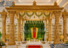 Grandeur Tirupati Balaji Mandap for Traditional Hindu Marriages South Indian temple mandap, luxury wedding mandap decor, temple style wedding stage, traditional wedding mandap, grand wedding backdrop, white and gold mandap, carved wedding stage, premium wedding decor, Indian wedding stage setup, royal wedding mandap, handcrafted mandap design, South Indian wedding decor, designer wedding stage, ornate temple backdrop, luxury wedding furniture, wedding event decor manufacturer, carved pillar mandap, wedding reception stage, Hindu wedding mandap setup