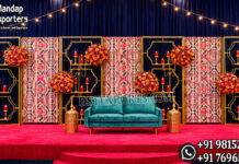 Modern Box Style Candle Wall Stands For Wedding Stage candle lit wedding stage, green gold wedding backdrop, candle wall wedding decor, luxury wedding stage backdrop, engagement stage green gold theme, wedding stage with candles, elegant wedding backdrop panels, floral frame wedding stage, modern wedding stage decor, reception stage backdrop design, candle light wedding decoration, designer wedding stage India, banquet hall wedding decor, wedding decor exporters India, premium event backdrop panels, wedding stage with green panels, contemporary wedding backdrop design