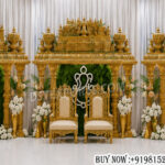 South Indian wedding manavarai, wedding manavarai stage, luxury wedding stage decor, traditional manavarai setup, golden wedding mandap, temple style wedding stage, carved wedding stage, premium wedding decor, Indian wedding backdrop, royal wedding stage, wedding stage decoration, handcrafted wedding mandap, Ganesh wedding backdrop, South Indian mandap decor, luxury wedding furniture, ornate wedding stage setup, designer wedding mandap, wedding event decor exporter, traditional wedding pavilion, grand wedding stage design