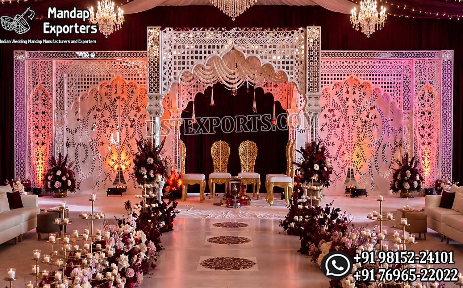 Luxury fusion wedding mandap featuring ornate white mirror-style carved panels, decorative arches, elegant chandeliers, burgundy drapery, floral aisle décor, ambient lighting, and royal seating for bride and groom.