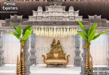 Custom Wedding Mandap for South Indian Ceremony Luxury South Indian temple wedding mandap featuring intricately hand-carved pillars, grand Gopuram temple architecture, banana trees, brass lamps, floral hanging décor, and an elegant wedding sofa, manufactured and exported by DST Exports for event planners, wedding decorators, and rental companies worldwide.