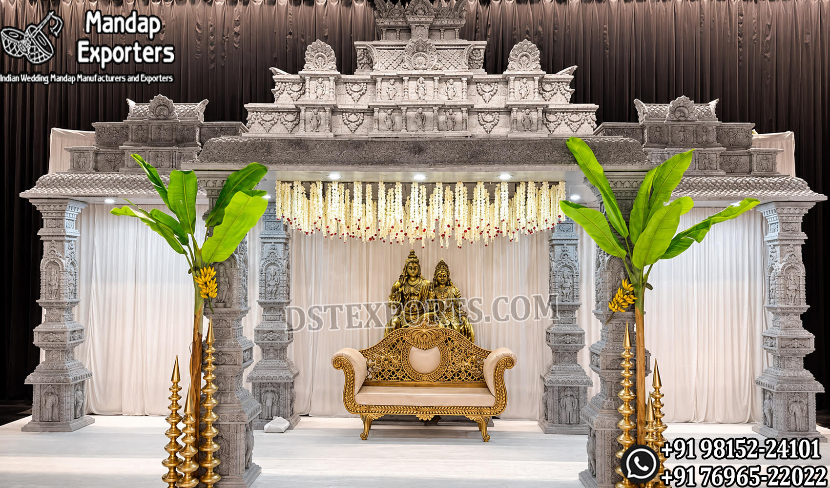 Luxury South Indian temple wedding mandap featuring intricately hand-carved pillars, grand Gopuram temple architecture, banana trees, brass lamps, floral hanging décor, and an elegant wedding sofa, manufactured and exported by DST Exports for event planners, wedding decorators, and rental companies worldwide.