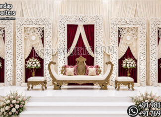 Elegant Fiber Frame Backdrops for Wedding & Reception Stages Elegant white carved fiber wedding backdrop frames with luxurious burgundy and ivory drapes, floral arrangements, and a royal wedding loveseat, creating a premium reception stage for Indian, South Asian, Hindu, Sikh, Muslim, and destination weddings. Perfect for luxury event planners, banquet halls, hotels, and wedding decorators in the USA.