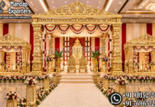 Grand Golden Manavarai Mandapam For Tamil Wedding Ceremony Grand Golden Tamil Manavarai Mandapam with intricately carved pillars and luxurious wedding stage décor for South Indian Hindu weddings, manufactured and exported for USA event planners, wedding decorators, banquet halls, and luxury wedding venues