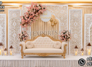 Royal Reception Stage Decor Manufacturer & Supplier Royal wedding reception stage backdrop with white laser cut panels, luxury sofa and floral decorations for Australian wedding decorators.