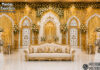 Grand Designer Arch Mirror Frame Wedding Stage Decoration Grand white and gold designer arch mirror frame wedding stage with floral panels, royal sofa, elephant statues and luxury decorations.