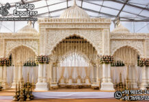 Grand White Gold Dome Style Indian Wedding Mandap Stage Grand white and gold dome-style Indian wedding mandap stage featuring carved pillars, Mughal arches and decorative backdrop panels.