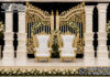 Luxury Bollywood Wedding Stage Setup with Gate Frame & Pillars Luxury Bollywood Wedding Stage Setup with White & Gold Gate Frame, Hand-Carved Decorative Pillars and Royal Bridal Chairs for Indian Wedding Reception | Wedding Stage Manufacturer & Exporter