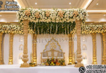 Luxury Carved Wooden Mandap Stage Set For Indian Weddings Luxury carved wooden Indian wedding mandap stage with traditional pillars, floral canopy and elegant gold detailing, designed for Hindu weddings, Phera ceremonies and luxury wedding events in the USA.