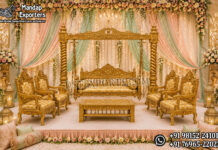Maharaja Hand-Carved Wooden Jhula Set For Mehndi Stage Maharaja Hand-Carved Wooden Jhula Set for Mehndi Stage featuring a luxurious carved wooden swing with matching royal chairs and center table in antique gold finish, displayed on an elegant floral wedding stage with pastel drapes. Perfect for Mehndi, Haldi, Sangeet, wedding receptions, luxury event planners, banquet halls, and destination weddings in the USA, UK, and Australia.