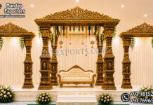 Tirumala Temple Fiber Mandap For South Indian Weddings Grand Tirumala Temple-inspired golden fiber mandap with eight carved pillars, ornamental crown tops and matching side frames for South Indian weddings.