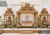 Traditional Grand Temple Style Wedding Mandap Setup Traditional grand temple-style wedding mandap with carved pillars, tiered crown tops, Lord Ganesha statues and natural wood finish.