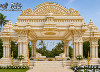 Traditional South Indian Temple Style Kalyana Mandapam Traditional South Indian Temple Style Kalyana Mandapam with intricately carved ivory and gold pillars, grand temple-inspired roof, luxury wedding stage, bridal seating, and decorative brass lamps for Hindu weddings, Indian wedding venues, and USA event decorators.