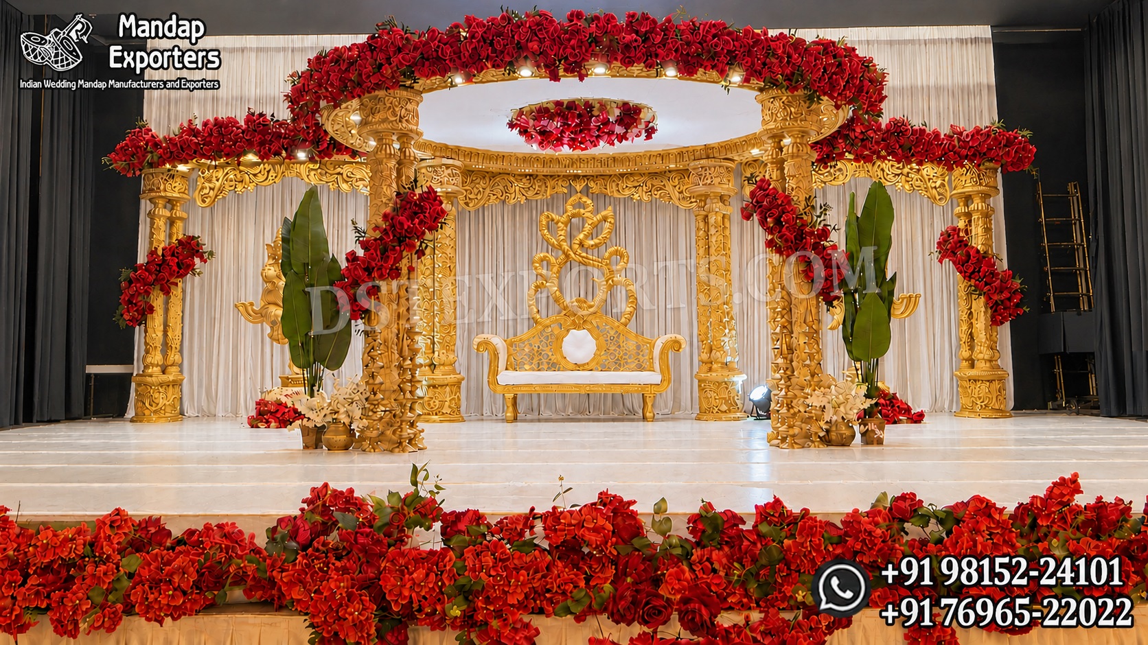 Grand gold carved Triveni mandap with temple-style pillars, circular canopy and red flowers for Hindu weddings.
