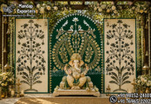 Grand Peacock Ganpati Entrance for Hindu Weddings Grand Peacock Ganpati Entrance for Hindu Weddings: Grand Peacock Ganpati wedding entrance with Lord Ganesha centerpiece, green and gold peacock backdrop and decorative tree panels.