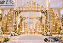Luxurious Gold Metal Candle Lit Wedding Mandap Set Luxury gold metal candle lit Hindu wedding mandap set with decorative golden pillars, elegant arches, romantic LED candlelight décor, and royal wedding stage design for Indian destination weddings.